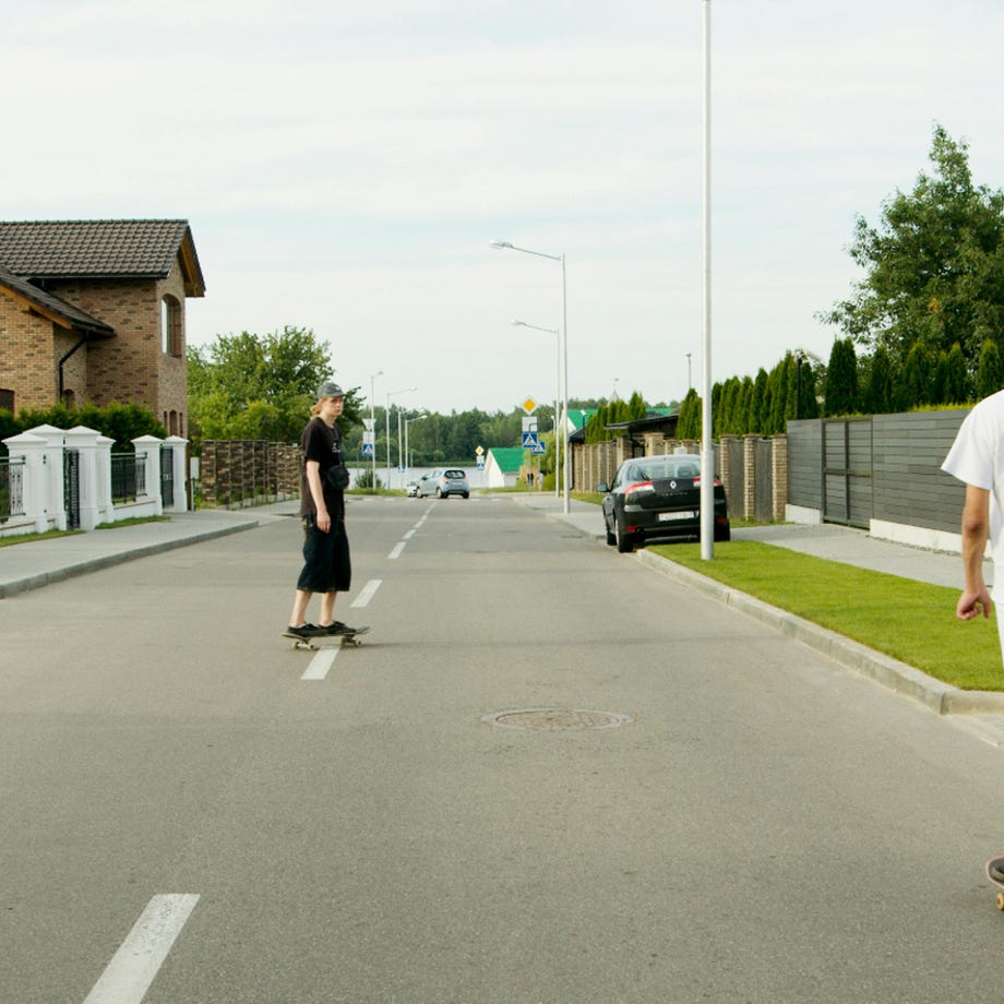 Man in Black T-shirt and Black Pants Walking on Sidewalk