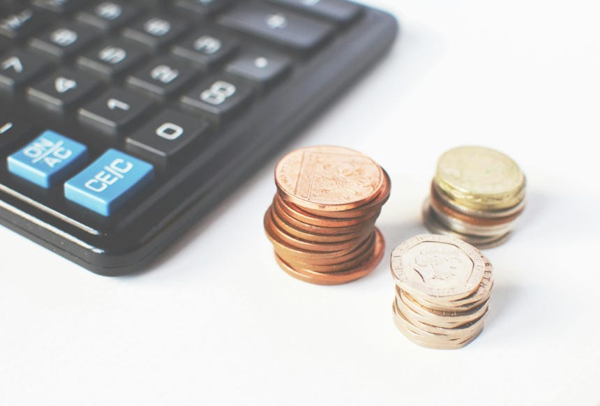 Gold-colored Coins Near Calculator